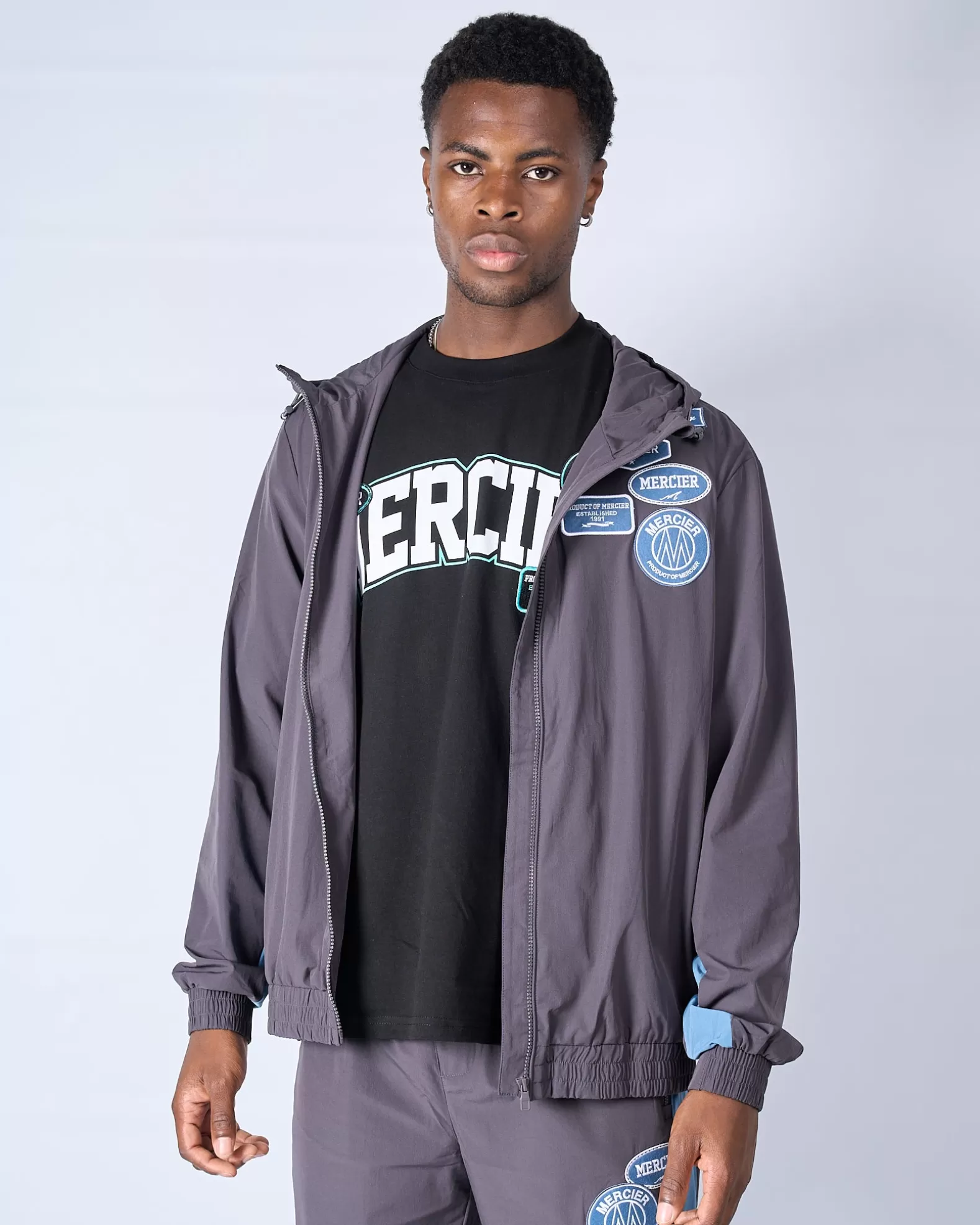 slate_flint_contrast_badge_windbreaker_4.webp Shop Mercier Slate Flint Contrast Badge Windbreaker